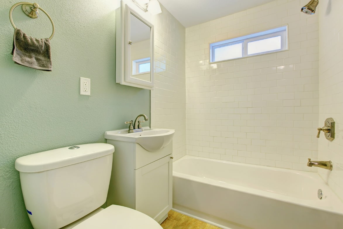 Bathroom with toilet, sink, and tub.